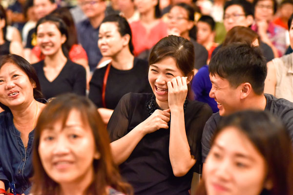 The amused faces of the parents as they watched the children on stage performing the musical (Photo by Lin Meng Cai)
